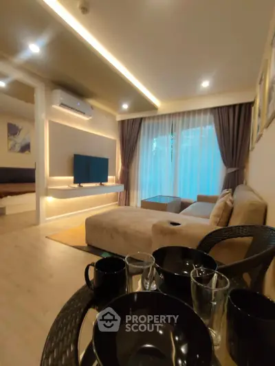 Modern living room with cozy seating and ambient lighting, perfect for relaxation and entertainment.