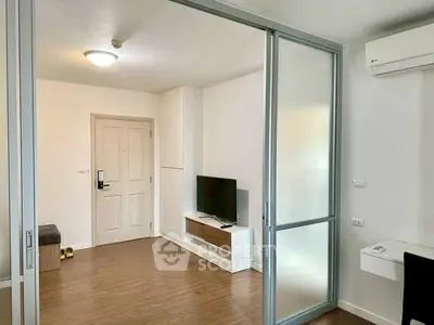 Modern living room with sliding glass doors and wooden flooring