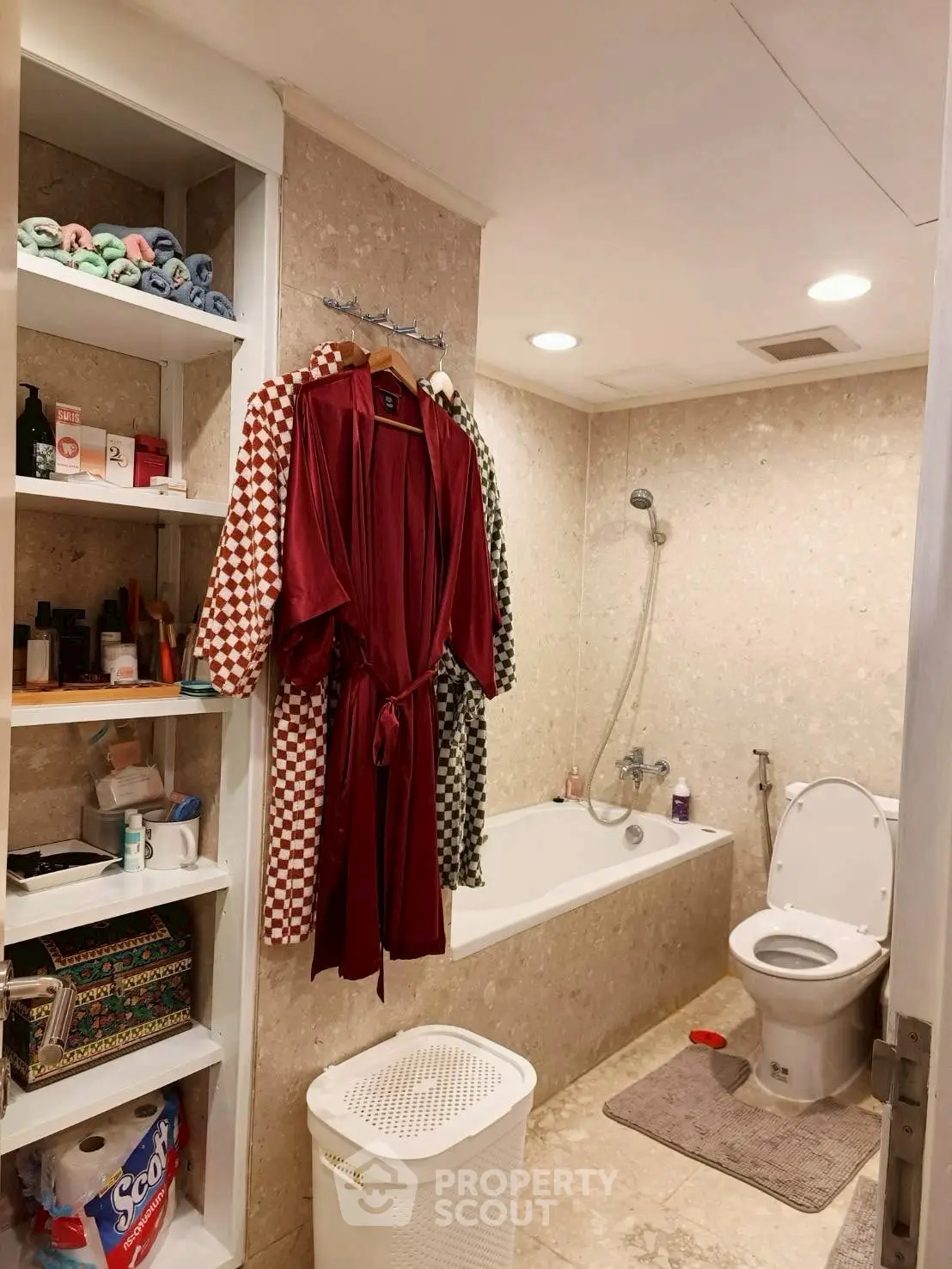 Cozy bathroom with bathtub and open shelving for storage