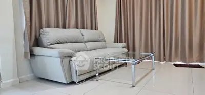 Modern living room with sleek leather sofa and glass coffee table