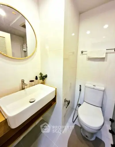 Modern bathroom with sleek fixtures and round mirror