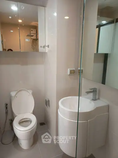 Modern bathroom with sleek fixtures and glass shower enclosure