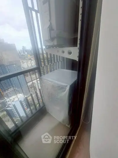 High-rise balcony with city view and air conditioning unit, perfect for urban living.