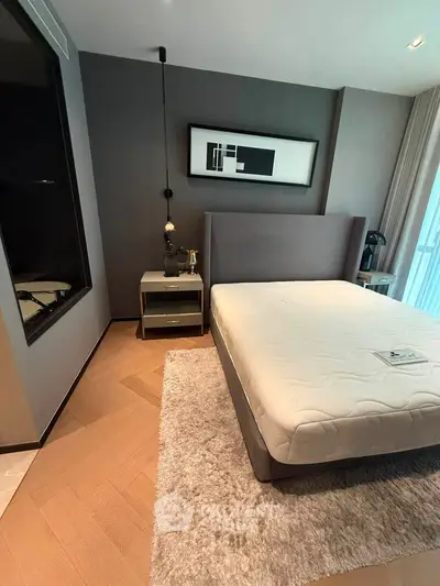 Modern bedroom with stylish decor and cozy ambiance, featuring a plush bed and elegant artwork.