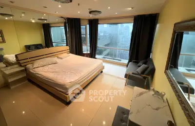 Luxurious bedroom with city view, featuring elegant furnishings and large windows for natural light.