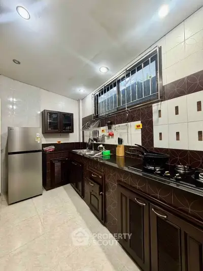 Spacious kitchen with modern appliances and elegant cabinetry, perfect for culinary enthusiasts.