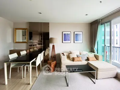 Modern living room with elegant decor and large windows offering natural light