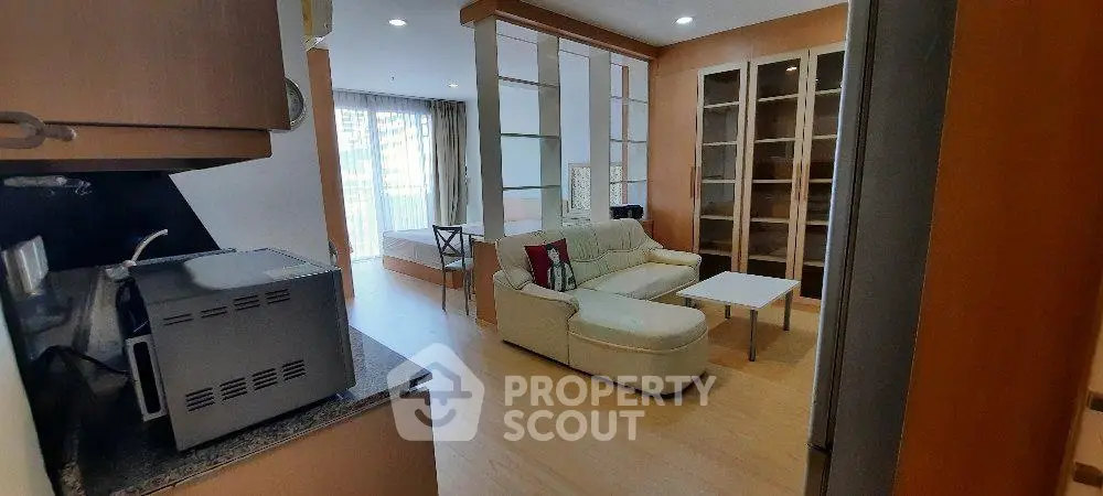 Spacious open-plan living room with modern kitchen and cozy seating area.