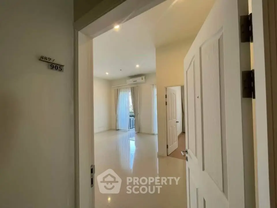 Spacious and bright living room with modern design and large windows in a high-rise apartment.