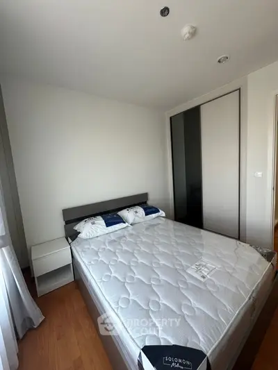 Modern bedroom with sleek design and comfortable bed in a stylish apartment.