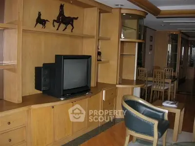 Spacious living room with wooden built-in shelves and classic decor