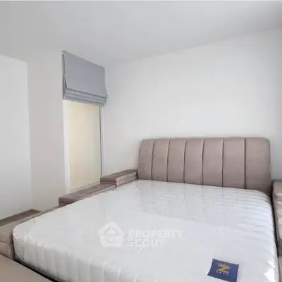 Spacious bedroom with modern bed and natural light