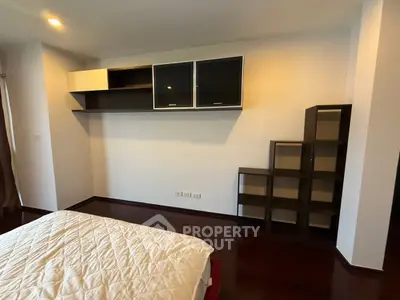 Modern bedroom with stylish shelving and cozy bed in elegant apartment