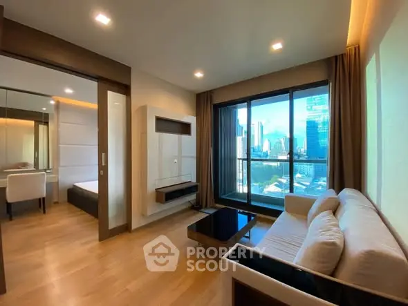 Modern living room with city view, featuring sleek furniture and large windows for natural light.