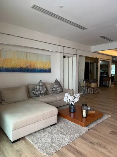 Spacious living room with modern decor and cozy seating area, perfect for relaxation and entertaining.
