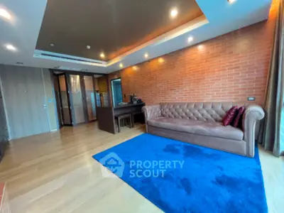 Spacious living room with modern decor and vibrant blue rug