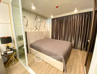 Modern bedroom with elegant decor and floor-to-ceiling curtains