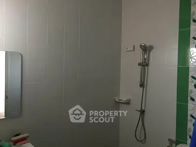 Modern bathroom with sleek shower and tiled walls