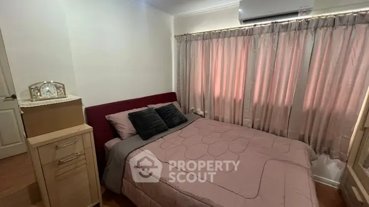 Cozy bedroom with stylish decor and natural light from window