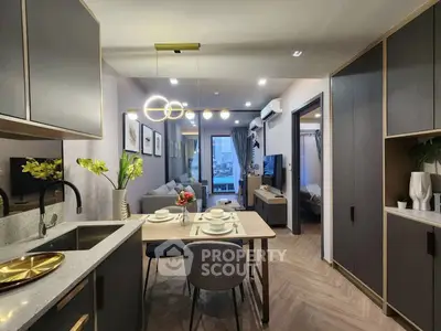 Modern open-layout kitchen and living room with stylish decor and elegant lighting