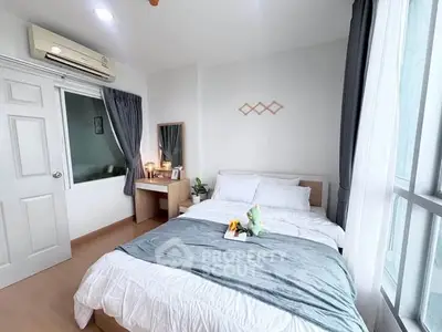 Cozy bedroom with natural light, modern decor, and a comfortable bed in a stylish apartment.
