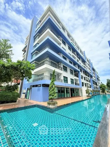 Modern condominium with poolside view and spacious balconies in a vibrant urban setting.