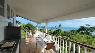 Stunning balcony with ocean view, perfect for outdoor dining and relaxation.