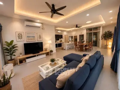 Spacious modern living room with open kitchen, stylish decor, and cozy seating area.