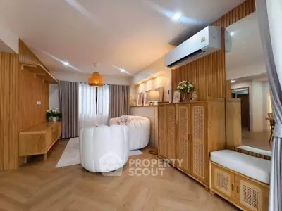Stylish living room with modern decor and wooden accents, featuring a cozy seating area and elegant lighting.