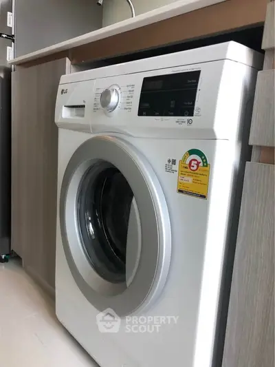 Modern washing machine in sleek kitchen setting, perfect for urban living.