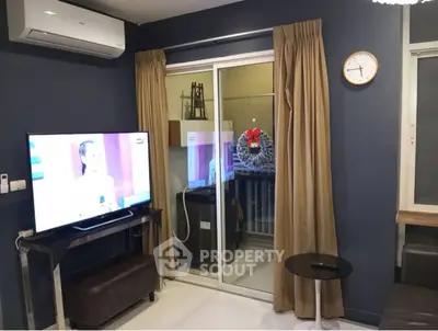 Modern living room with TV, air conditioning, and balcony access.