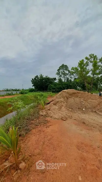 Expansive plot of land with lush greenery, perfect for development opportunities.