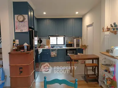 Charming kitchen with blue cabinets and modern appliances in cozy home setting.