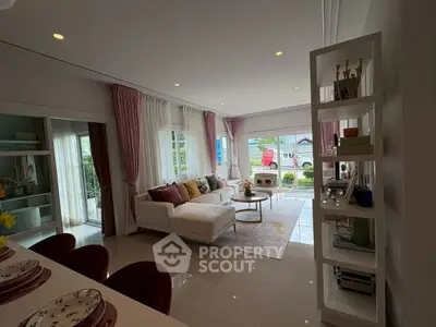 Spacious living room with elegant decor and large windows offering natural light