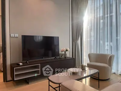 Modern living room with sleek furniture and large windows offering natural light.