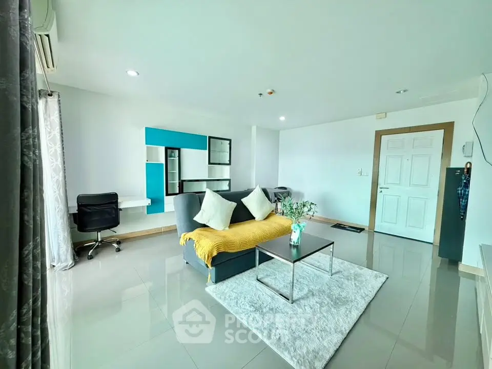 Spacious modern living room with sleek furniture and bright natural lighting