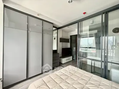 Modern bedroom with sleek wardrobe and city view from window