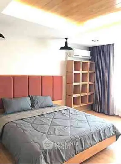 Modern bedroom with stylish decor and ample natural light