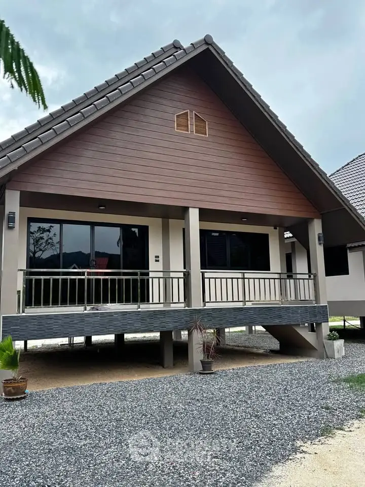 Charming elevated house with modern design and spacious balcony, perfect for serene living.