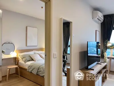 Modern bedroom with stylish decor and natural light, featuring a cozy bed and contemporary furniture.