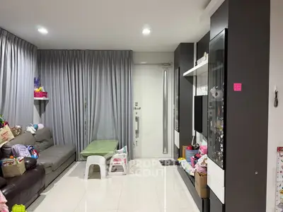 Modern living room with sleek furniture and floor-to-ceiling curtains