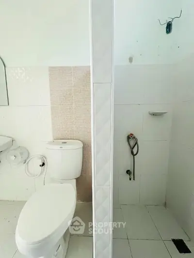 Modern bathroom with white tiles and separate shower area
