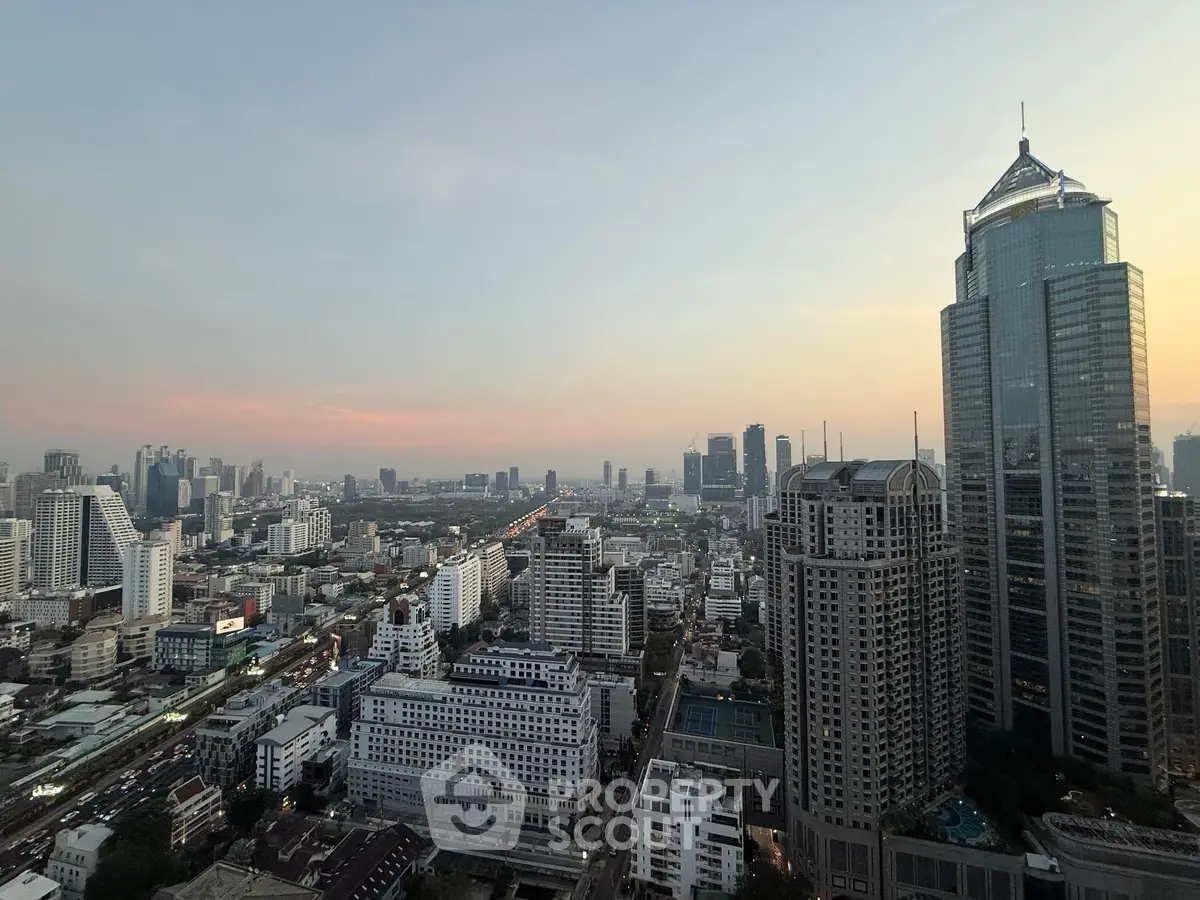 Stunning cityscape view from a high-rise building at sunset, showcasing urban skyline.