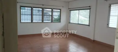 Spacious empty room with large windows and tiled flooring, ideal for customization.