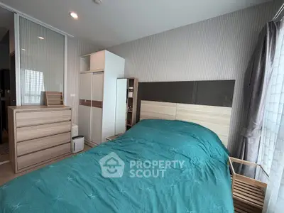 Modern bedroom with teal bedding and sleek wooden furniture