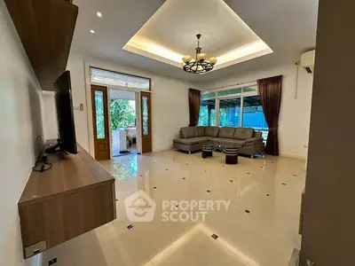 Spacious living room with modern decor and large windows for natural light.