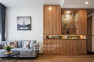 Modern living room with elegant wooden cabinetry and stylish decor.