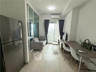 Modern living room with balcony view, sleek furniture, and natural light in a high-rise apartment.