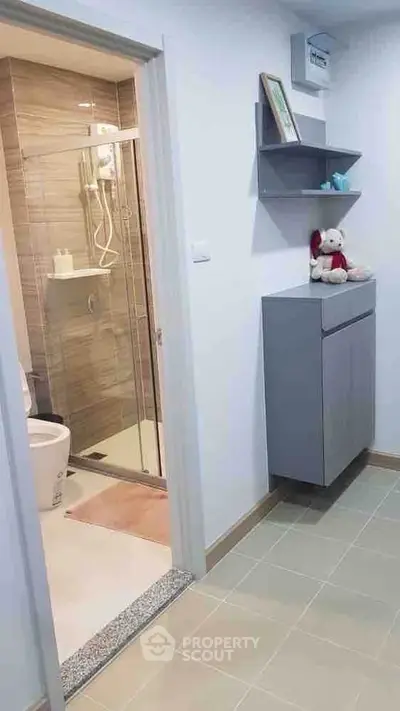 Modern bathroom entrance with sleek design and stylish storage solutions.