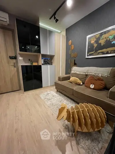 Modern living room with stylish decor and unique wooden sculpture, featuring cozy sofa and elegant wall art.